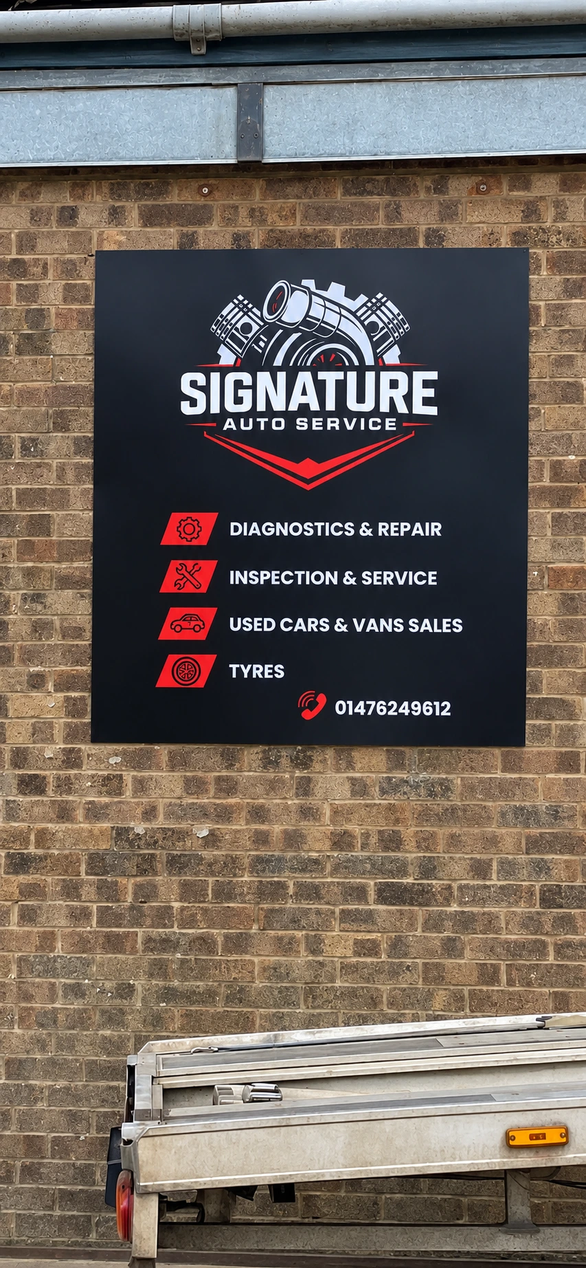 Signature Auto Service logo and services on installed workshop signage